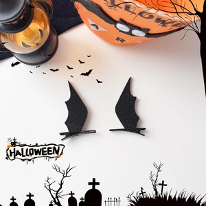 Detail of Halloween black bat wing hair clips made of thick felt on metal pins