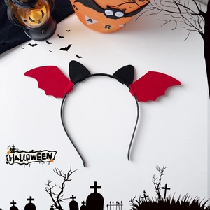 Detail of a Halloween devil bat headband with red wings and black ears for party dress-up