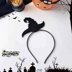 Detail view of black felt witch hat headband on a festive Halloween background