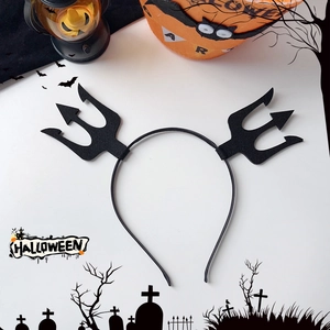 Top view of black devil trident headband with Halloween pumpkin and bat decorations