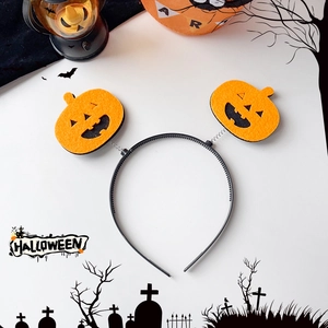 Detail view of Halloween pumpkin headband with orange felt faces and bouncy metal springs