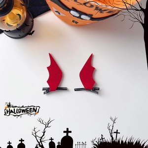 Pair of red felt bat wing hair clips for Halloween party costume accessories on white background
