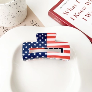 Detailed close-up of a rectangular acrylic hair claw clip with American flag pattern design