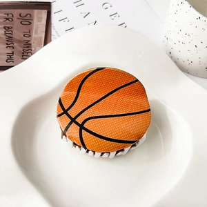 Detalle de la pinza para el pelo redonda de acrílico con diseño de baloncesto