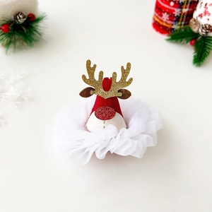 Close-up of a festive Christmas hair clip featuring a Santa hat, reindeer horns and lace