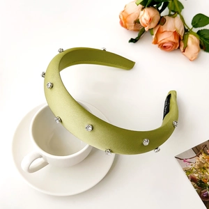 Detail of light green satin rhinestone headband with thick sponge and luxury crystal decor