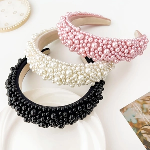 Detailed view of wide baroque sponge headbands with multi-sized faux pearls in pink and black