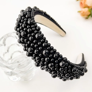 Close-up of black wide headband with hand-stitched pearls and soft anti-slip lining