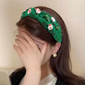 Serre-tête de Noël vert à nœud avec perles et strass porté par un mannequin de profil