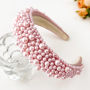 Detailed side view of a thick pink sponge headband with multi-sized faux pearls