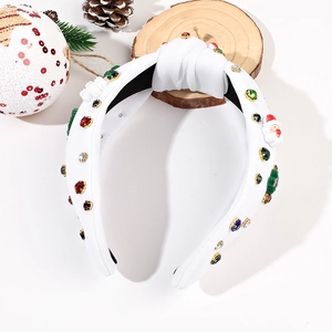 Détail de serre-tête de Noël blanc avec strass colorés et ornements de Père Noël et sapin