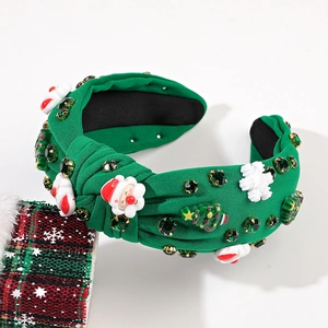 Gros plan d'un serre-tête noué vert avec figurines 3D du Père Noël et de sapins