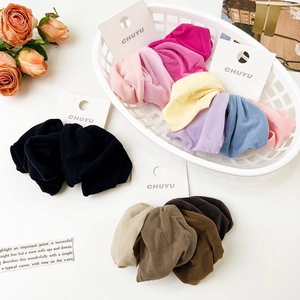 Macro shot of multi-colored soft scrunchies set with elastic fabric on white card