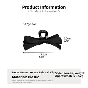 Dimensions détaillées de la pince à cheveux nœud noir montrant 15,2 cm de long et 6 cm de haut