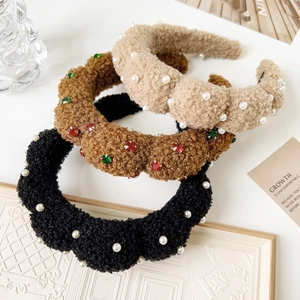 Detailed view of three plush velvet headbands with pearls and colorful crystals