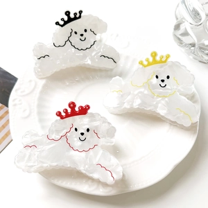 Detalle de pinzas de pelo de cachorros con textura nacarada sobre un plato blanco