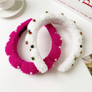Detail of plush lamb wool headbands with colorful rhinestones and faux pearls