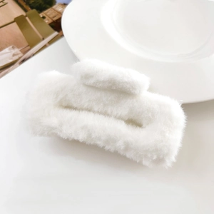Detailed close-up of a premium white plush square hair claw clip with soft faux fur texture