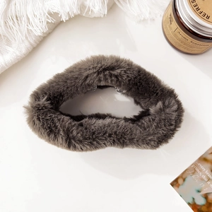 Detailed close-up of dark brown plush hair claw clip with soft faux fur and silver metal