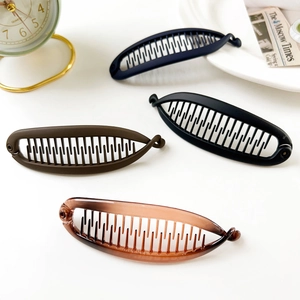Detailed set of four banana hair clips in navy, black, coffee, and amber resin colors