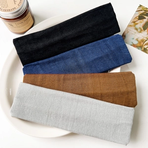 Close-up of four-color elastic knitted headbands featuring fine vertical ribbed textures