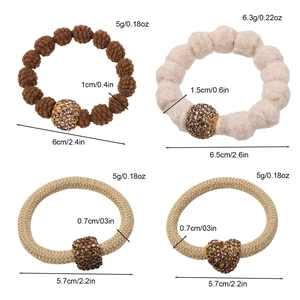 Set of four brown and beige plush elastic hair ties with detailed sizing and golden charms
