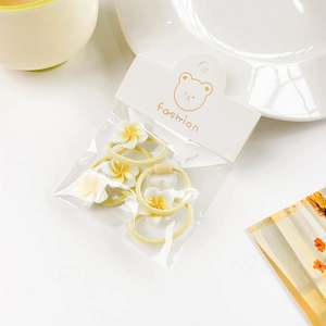 Set of 5 elastic hair ties with white and yellow frangipani flowers in cute packaging