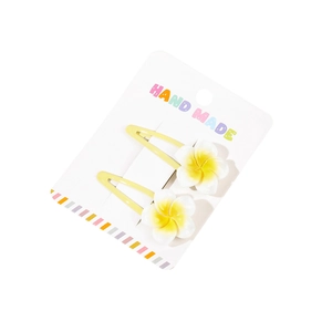 Set of two Y2K plumeria flower hair clips with white and yellow gradient on a card