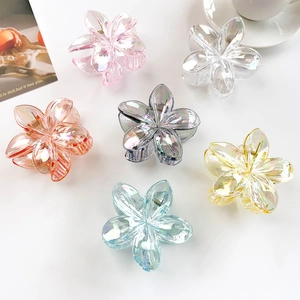 Close-up of six-piece matte flower hair claws with iridescent pearlescent finish