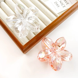 Detail of matte and translucent plumeria hair claws with durable metal springs