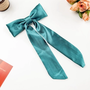 Eleganter pfauenblauer Satin-Haarclip mit langen Bändern auf weißem Hintergrund Dekor
