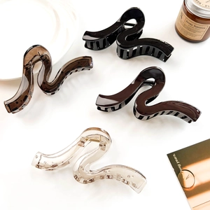 Elegant geometric wave shark hair clips in black, brown, and tea colors for women