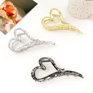 Three-piece liquid metal heart hair claws in gold, silver, and gunmetal finishes