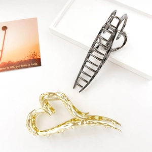 Detail of premium liquid metal hollow heart hair claw clips with wavy texture