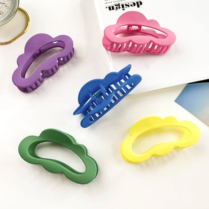 Close-up of five matte cloud-shaped hair claws in vibrant dopamine colors