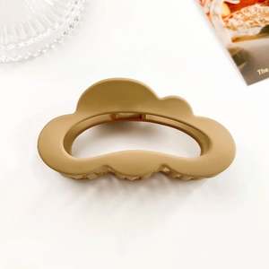 Detailed view of ginger yellow cloud-shaped hair claw clip with matte frosted finish