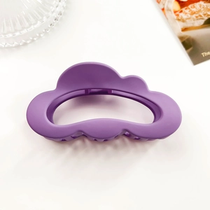 Detail view of purple matte cloud-shaped hair claw clip with spring opening mechanism