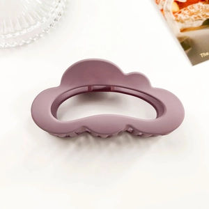 Detail of matte purple cloud hair claw clip with a hollow design and wavy outline