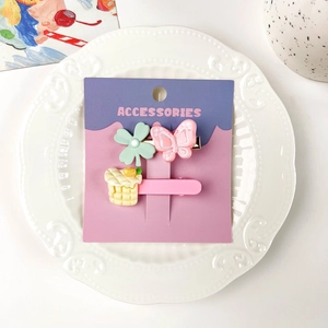 Détail d'un lot de 3 barrettes mignonnes avec papillon et trèfle sur carte support