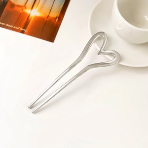 Elegant U-shaped silver metal hair pin with minimalist heart design on a white aesthetic background