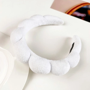 Macro view of white microfiber cloud sponge headband with soft bubble texture