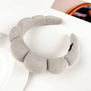 Detail of gray plush thickened spa headband showing soft microfiber texture and inner label