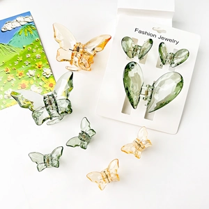 Transparent butterfly hair clips set in amber and green resin for women hairstyles