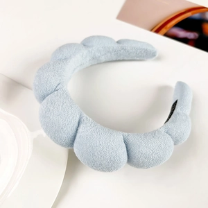 Detail of light blue puffy cloud headband made of soft terry cloth material