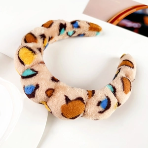 Close-up of the plush thickened headband with colorful leopard spots and soft faux fur texture
