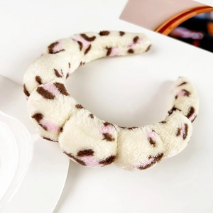 Close-up of leopard print plush headband with soft flannel texture for skincare