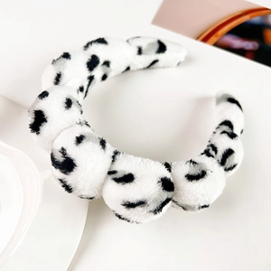 Detail shot of the plush polka dot headband showing soft faux fur texture and cloud design