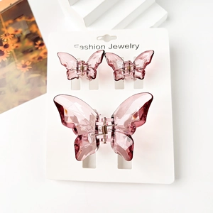 Detailed set of three translucent butterfly hair clips with faceted resin design