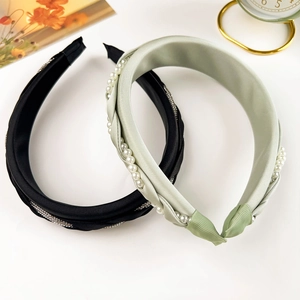 Elegant woven pearl headband set with shimmering rhinestones in black and sage green colors
