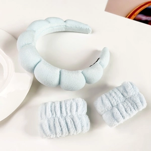 Close-up of soft light blue padded cloud headband and matching plush wrist washbands set